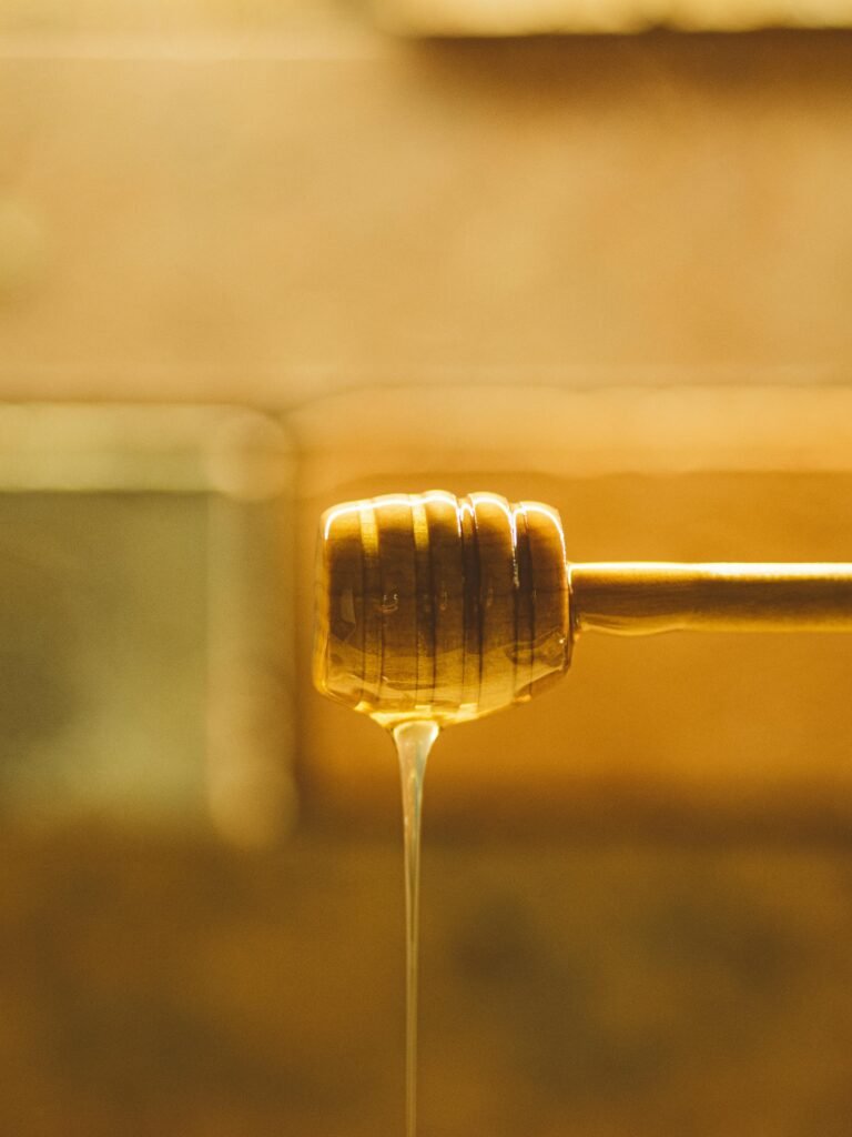 Honey is falling from spoon